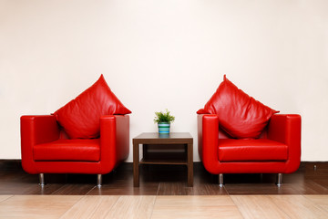 Red leather chairs with pillow