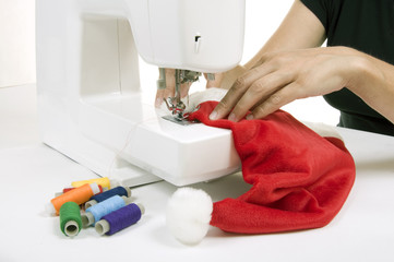 woman sewing a hat for Santa Claus
