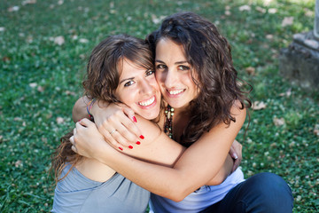 two girls hugging themselves tightly