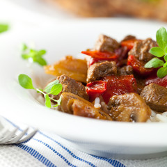 Beef goulash with mushrooms, rice and fresh herbs