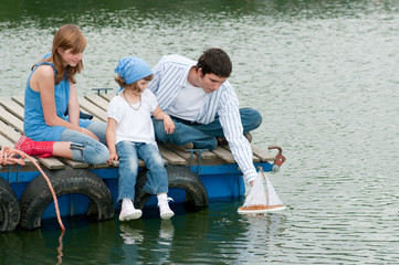 Fototapeta na wymiar Family playing at the pier