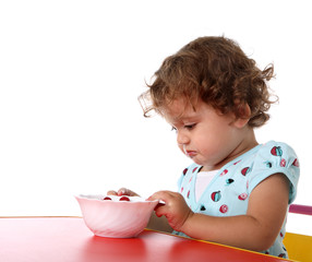 Sad little girl at table