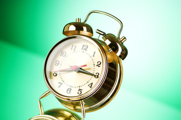Time concept - alarm clock against colorful background