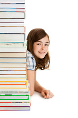 Student sitting behind pile of books on white