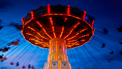 Action photo of carousel at sunset