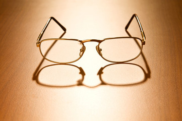 Reading glasses on the wooden table