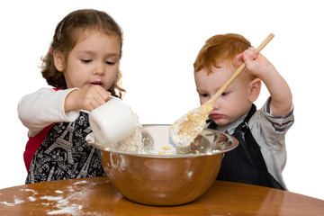 Kids measuring and mixing in kitchen
