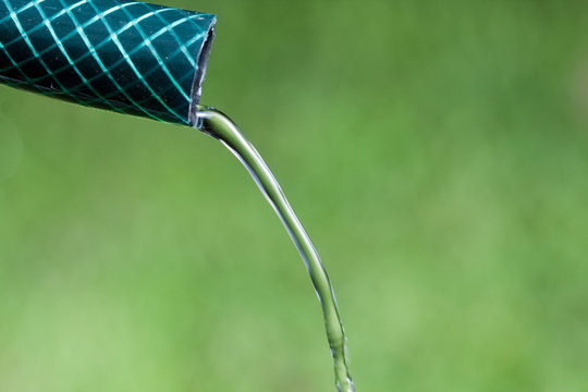 Closeup Of Water Running From Garden Hose