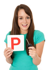 Teenager holding P plate and car key