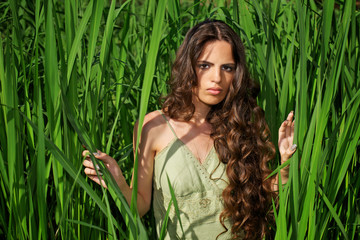 Fototapeta premium Portrait of beautiful woman with long curly hair