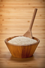 Rice on bowl and wooden spoon