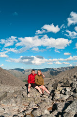 Father and son on peak of mountain.