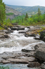 Waterfall cascade in khibins mountain, Russia