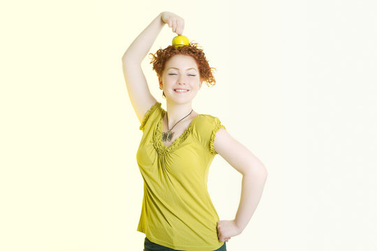 caucasian girl making an exercise with green nice apple