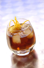 Appetizer Bunueloni with ice cubes and slices of orange skin