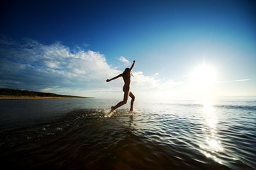 Happy girl running in the sea