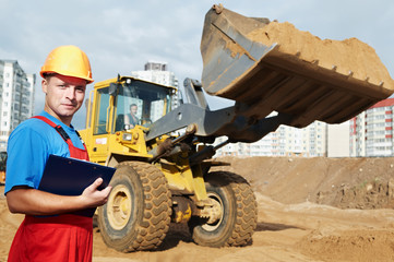 smiling Builder inspector at construction area