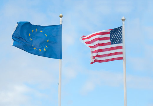 american and european flags in wind