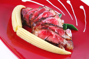 meat served on white with corns