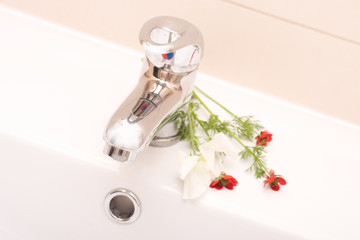 bathroom faucet and flowers