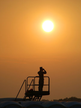 Military Sentry Looking in Front of Sunset