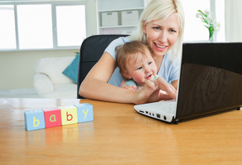 Enthusiastic daughter sitting in front of the laptop