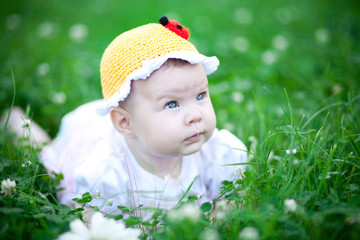 Adorable baby girl outdoors in the grass