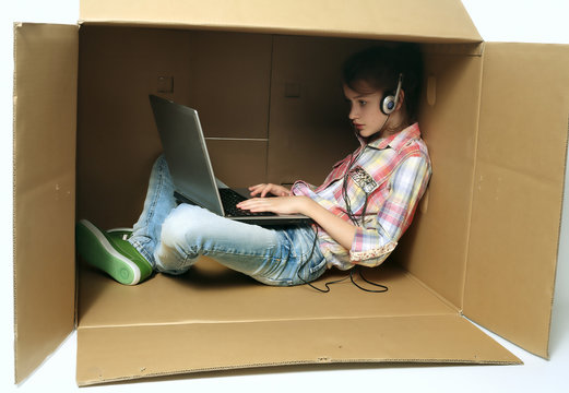 Little girl and laptop in the box.