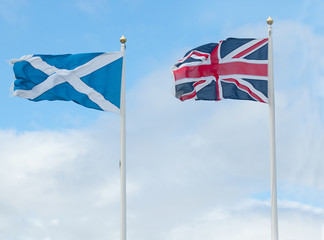 scotland and british flags in wind