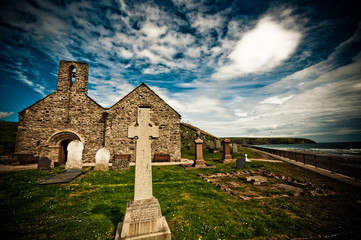 church and graveyard with view of the coastline