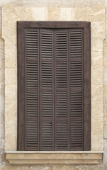 Window with brown shutters.