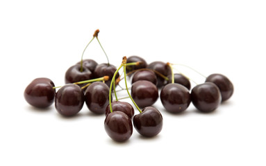 handful of dark cherries isolated on white background