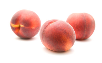 three ripe red peaches isolated on white background