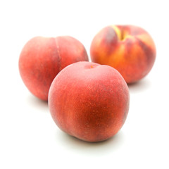 Fototapeta na wymiar three ripe red peaches isolated on white background