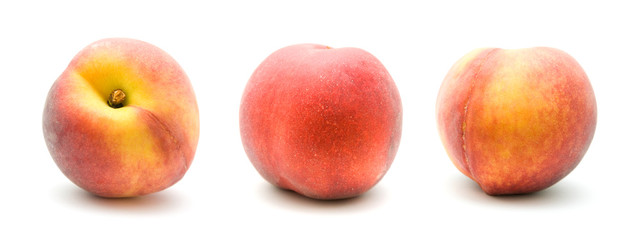 three ripe red peaches isolated on white background;