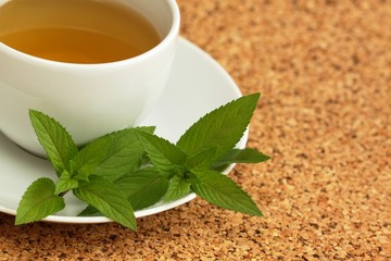Cup of herbal tea and  mint leaves © svehlik