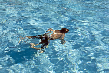 happy child is diving in the pool