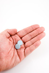 hand holding indigestion pills