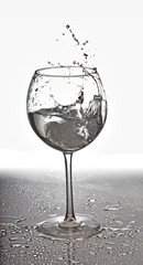 Splash in glass of water and ice