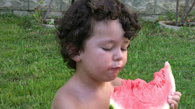 Little Boy eating watermelon