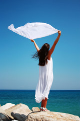 Girl with kerchief on the cliff. Relax scene.