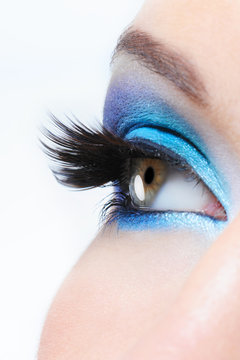 female eye with bright blue  make-up