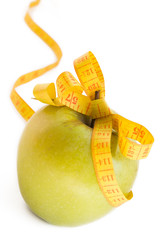 Apple and  measure tape isolated on white