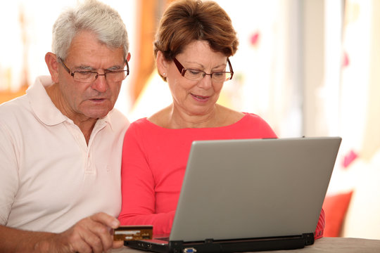 Closeup of senior couple doing online shopping