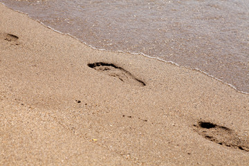 Foot steps on the beach