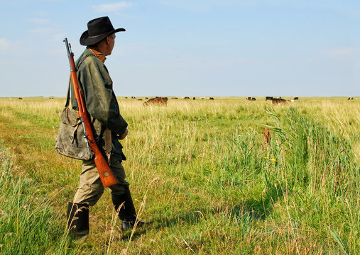 Hunter walking on the prairie