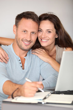 Couple at home surfing on internet