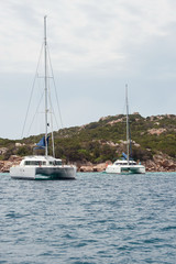 Obraz premium two anchored catamarans near Sardinia