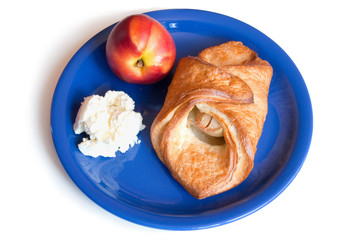croissant, peach and cream cheese on a plate