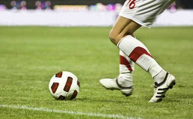 Soccer player running after the ball